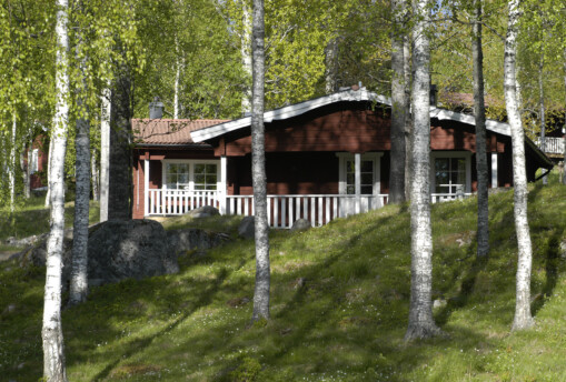 Röd stuga Östanvik i Säfsen, sommar.