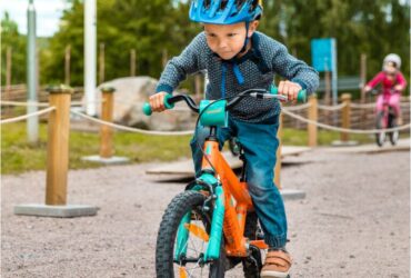 Lära sig cykla i Säfsen. Liten pojke cyklar koncentrerat på MTB