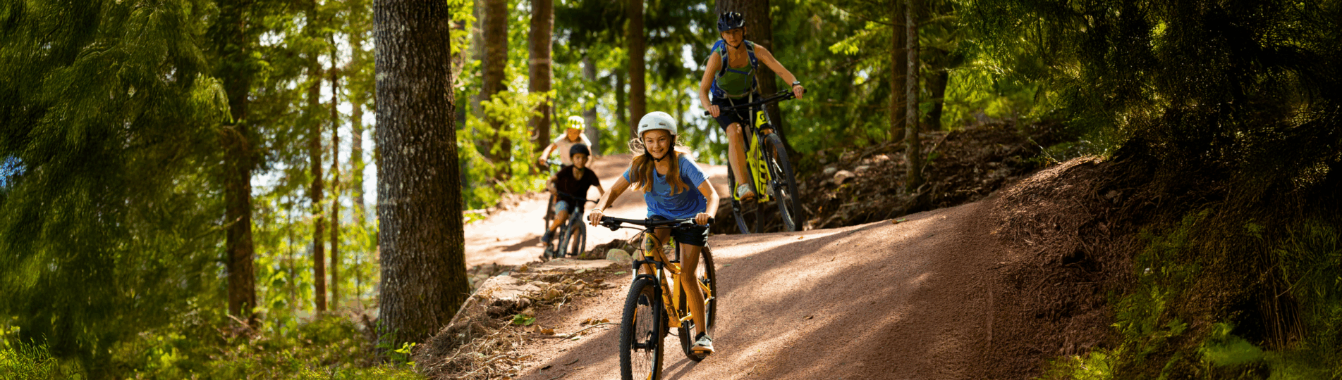 3 personer cykler mountainbike på en fin led i solsljuset